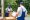 Man mover worker in blue uniform check lists on clipboard while unloading cardboard boxes from truck